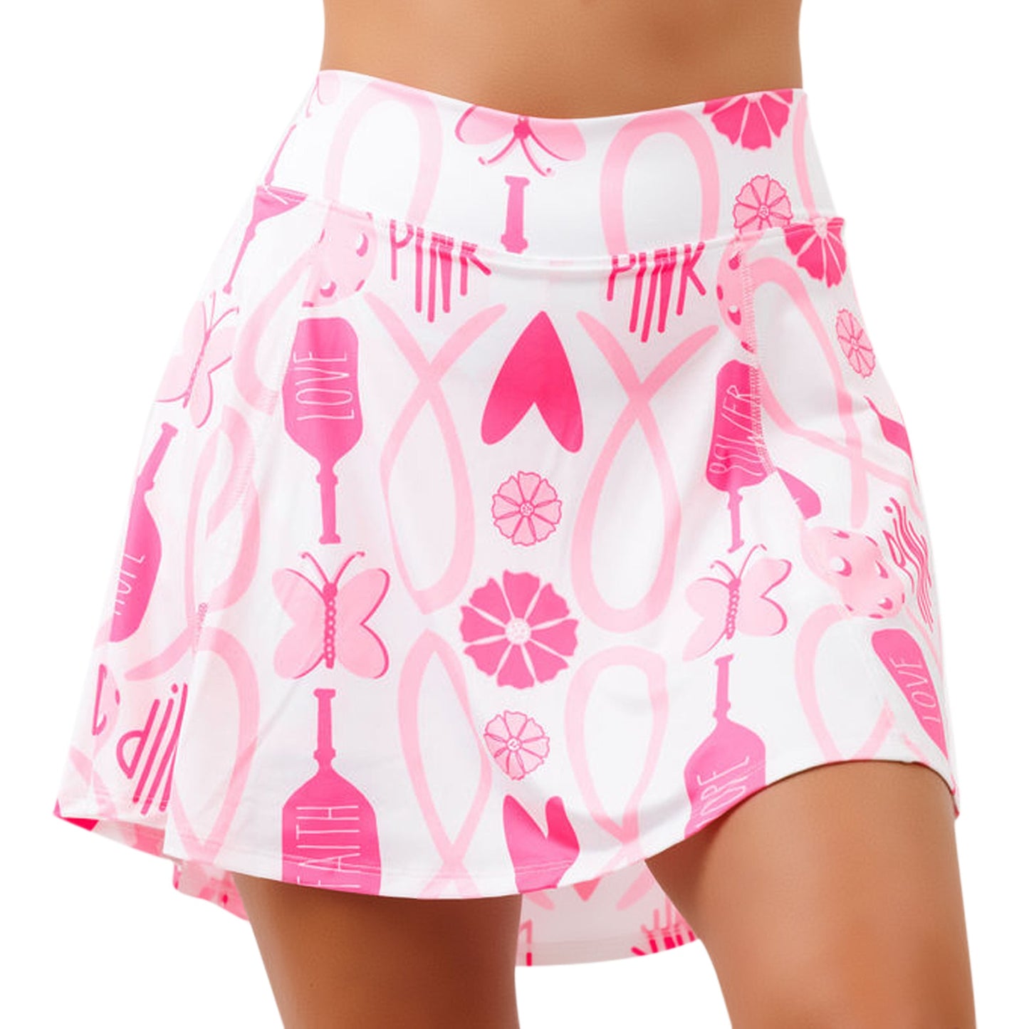A woman wears the PB Aline Skort Hope by Pickleball Bella, featuring bold pink butterflies, flowers, hearts, and “PINK”—its flared style and playful design spread breast cancer awareness with every step.
