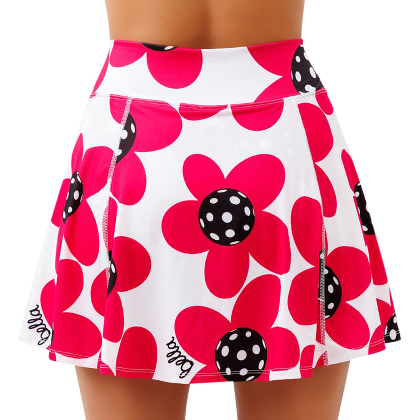A woman wears the Pickleball Bella PB Aline Skort Poppy, a white 4-way stretch skort with bold red poppies featuring black centers with white polka dots. "Bella" is written at the hem. The background is plain white.