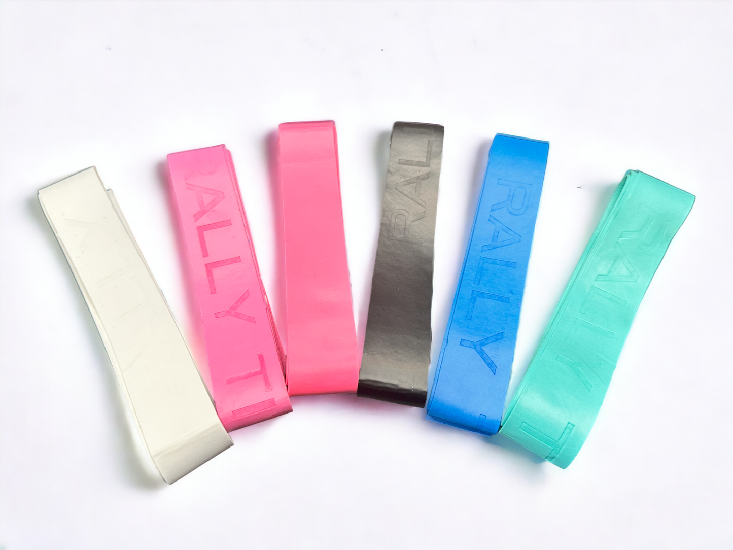 Five Over Grip flat resistance bands by Rally Titan Pickleball, in white, pink, red, black, blue, and green, are displayed side by side on a white background. Each anti-slip band is embossed with the word "RALLY.