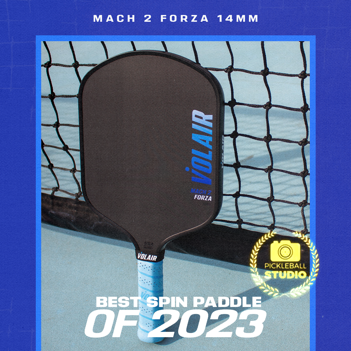 A USAP approved Volair Pickleball Mach 2 Forza Pickleball Paddle stands upright on a blue court in front of a net. White and blue text reads, Best Spin Paddle of 2023, with a gold Pickleball Studio seal beside the paddle.