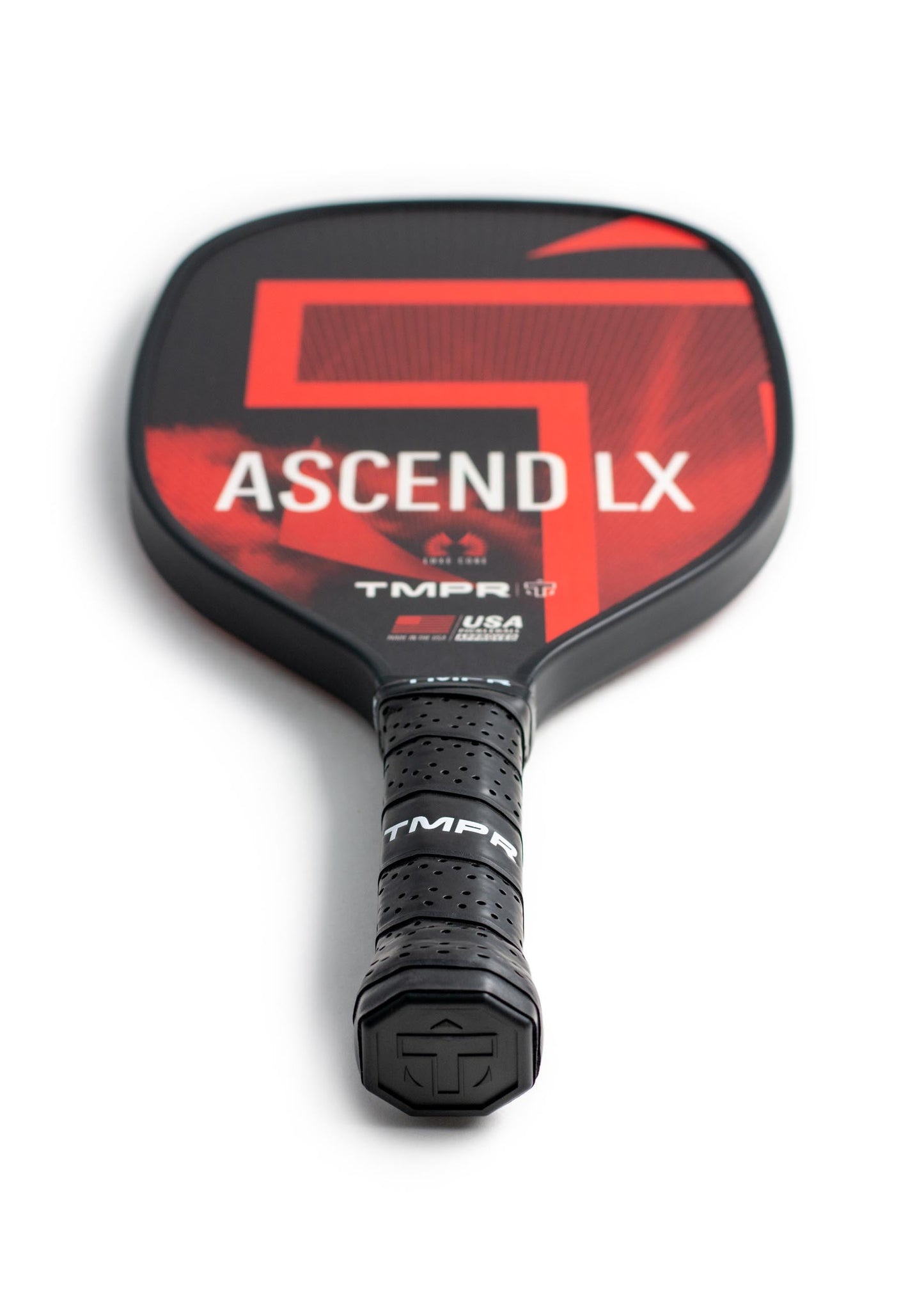 A close-up of the TMPR Sports Ascend LX black and red fiberglass pickleball paddle with a textured black grip, labeled ASCEND LX. A large red number 7 appears in the background. Durable honeycomb polymer core. Shot on white.