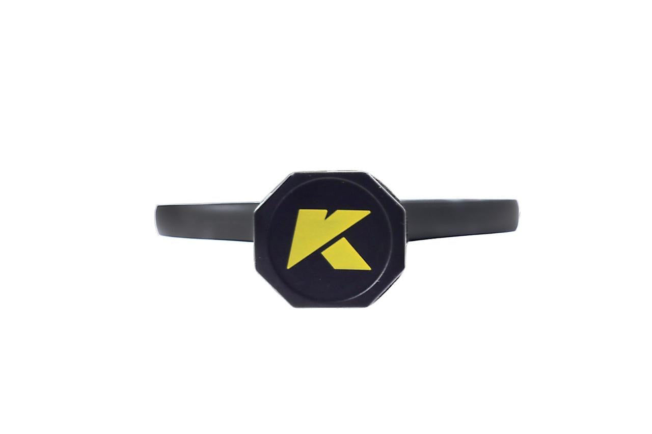 The DUNE 3K Carbon Pickleball Paddle by KONDOR PICKLEBALL features a black octagonal ring and a bold yellow K at its center, reflecting the sleek, solid surface of its advanced 3K carbon face on a plain white background.