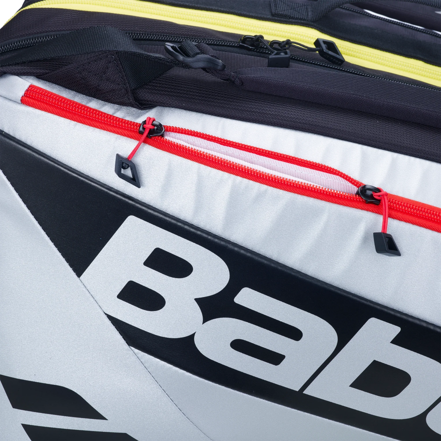 Close-up of the Babolat RH PRO Padel Bag from Padel USA, featuring three zippered compartments with yellow, black, and red zippers. Its bold logo on a white and black background adds a sporty style for expert players.