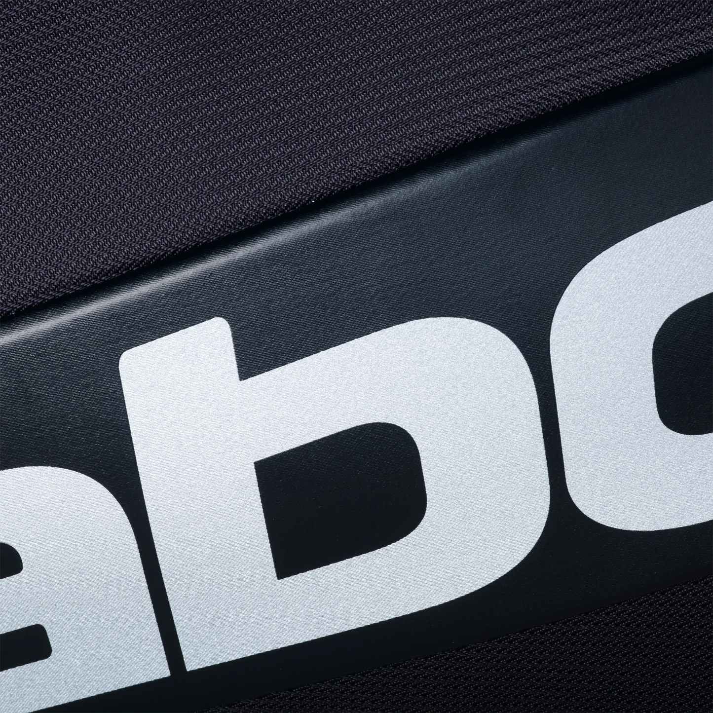 Close-up of the textured black surface and bold white lettering from the Babolat RH PRO Padel Bag by Padel USA, highlighting its high-quality design for expert players.