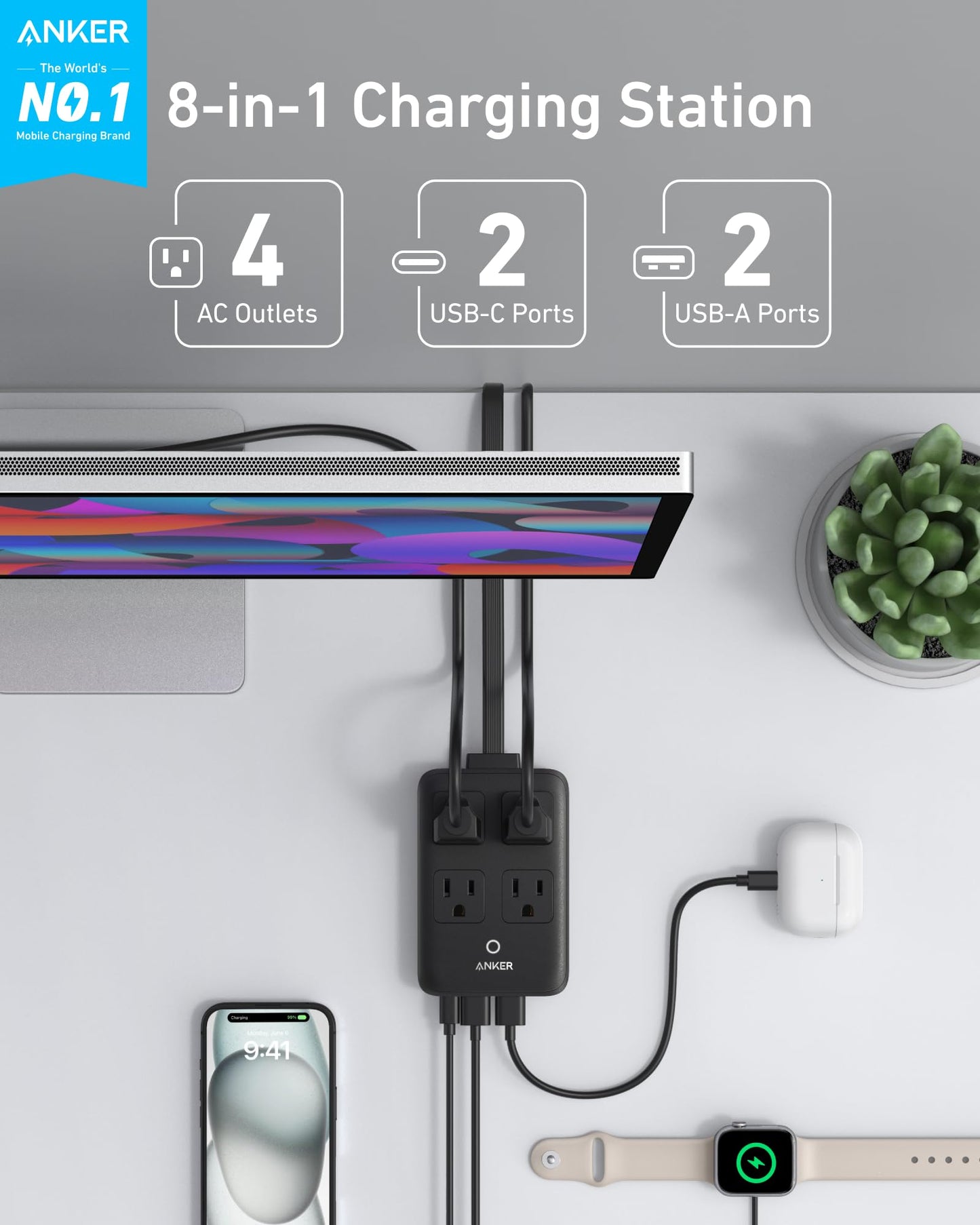 The black Anker Charging Station (8-in-1, 20W) by Anker sits on a desk, powering a monitor, iPhone, Apple Watch, and AirPods via four AC outlets, two USB-C ports, and two USB-A ports. The Anker logo is visible; a potted plant is nearby.