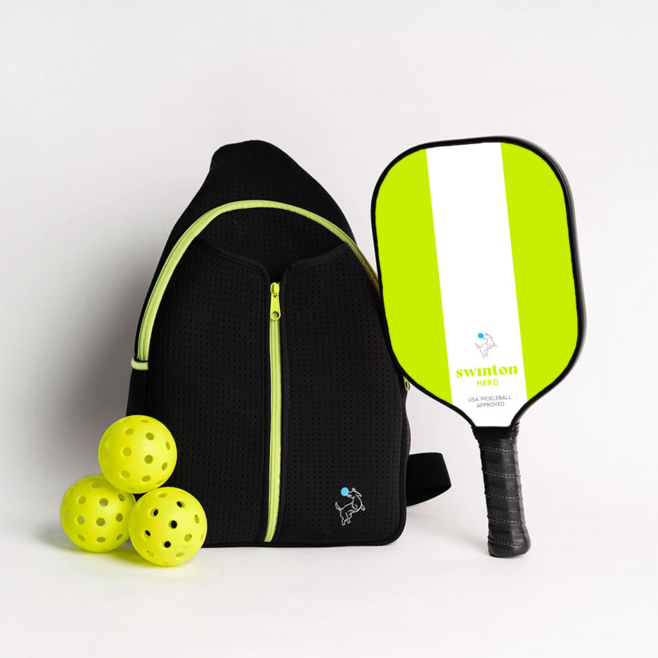 The Swinton Pickleball Starter Bundle - Black Sling Bag Combo includes a black bag with lime green accents, a lime green-and-white paddle wrapped in black grip tape, and three yellow pickleballs, all arranged on a white background.