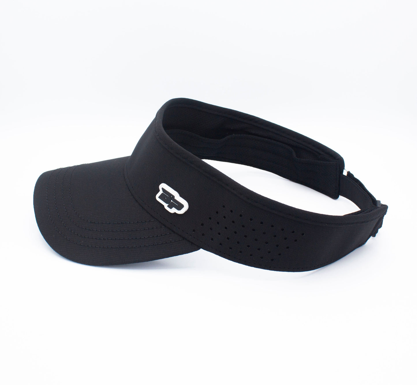 The Bodhi Performance ICON Visor is a black performance visor with a curved brim, small ventilation holes along the band, and a white and black embroidered logo on the left side, shown angled against a plain white background.