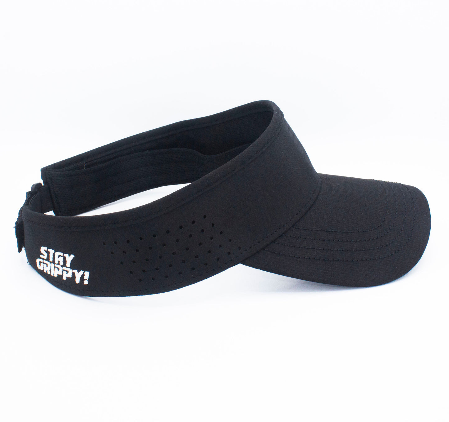 The Bodhi Performance ICON Visor is black with a curved brim, perforated for ventilation, and features white "STAY GRIPPY!" embroidery on the left. It has an adjustable strap and is shown on a white background.