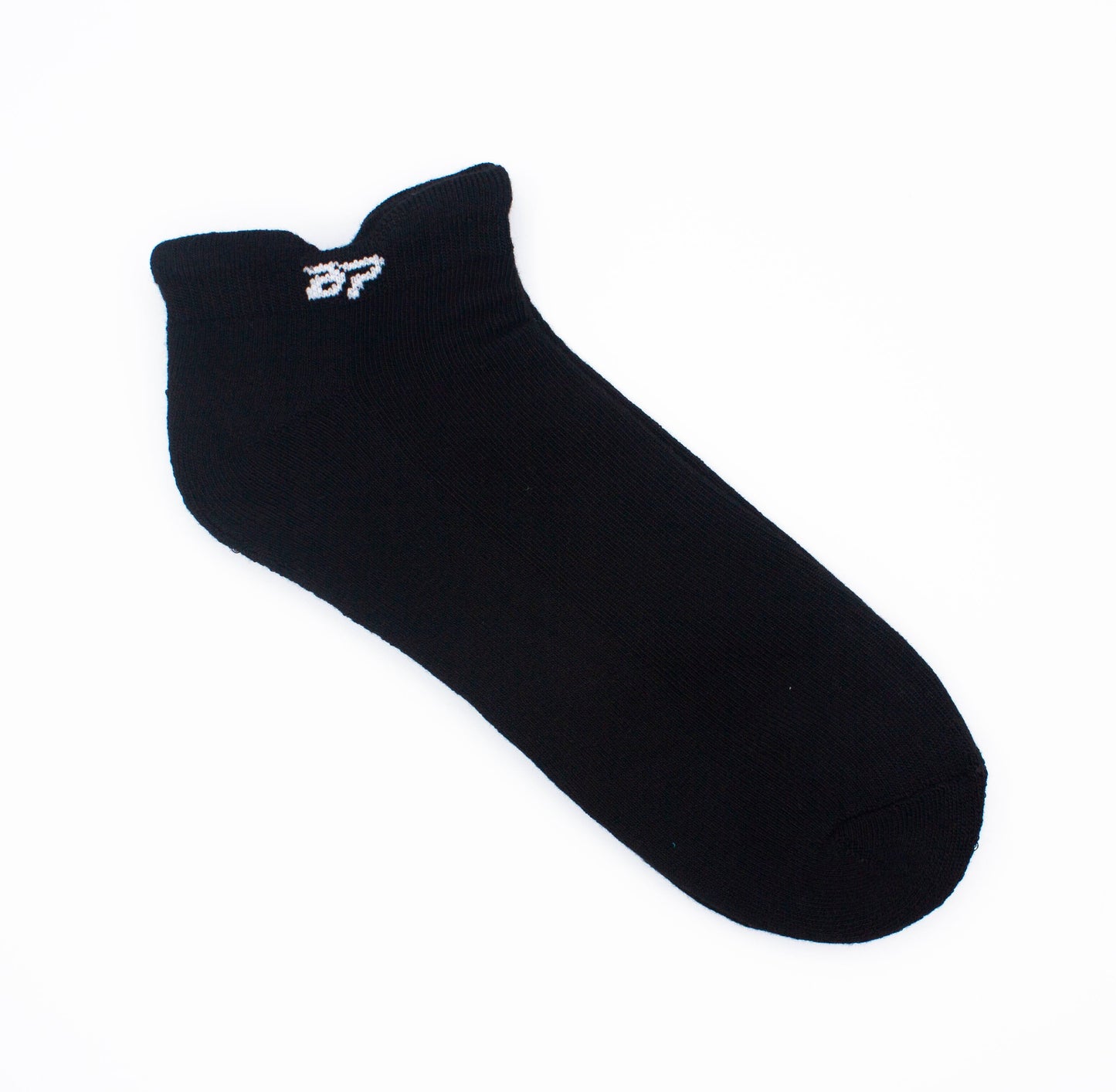 A single black Performance Sock by Bodhi Performance lies flat on a white background, featuring a ribbed cuff for support, smooth toe area, and small white “B7” embroidery near the cuff.