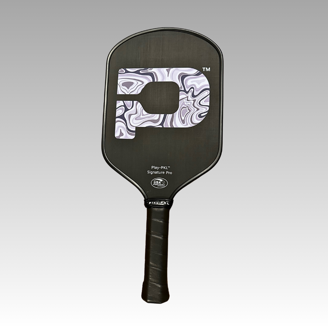 The Playly Store Signature Pro Pickleball Paddle features a black carbon fiber face with a marbled white and gray P logo, wrapped black grip, and rounded rectangular shape. USA Pickleball Approved, shown on a gray gradient background.