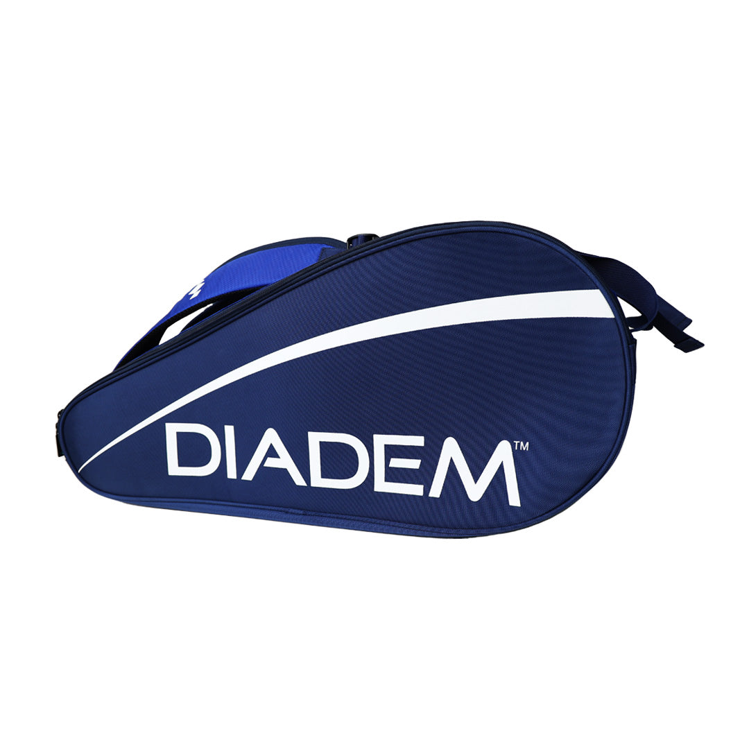 The Diadem Sports Tour v3 9PK is a blue tennis racket bag with a white curved stripe, bold DIADEM lettering on the side, top zipper, and black adjustable shoulder strap, displayed on a plain white background.