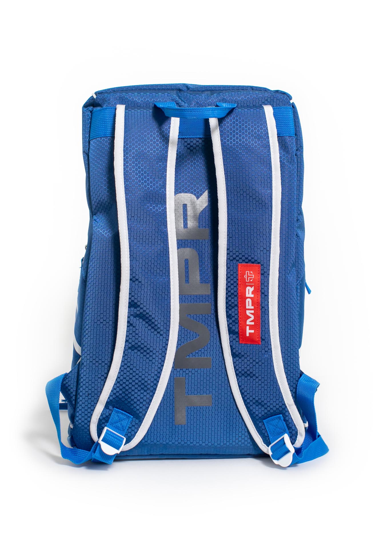 The TMPR Sports Tour 2 Backpack in blue is displayed from the back, with white adjustable shoulder straps edged in blue, gray vertical "TMPR" branding, and a red tag accent—an eye-catching pickleball backpack on a white background.
