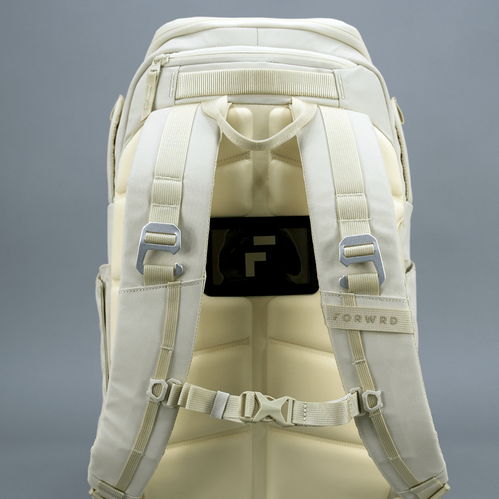 The FORWRD Court Caddy Pickleball Bag is displayed from the back against a gray background, featuring padded straps, a sternum strap, metal buckles, and a black patch with the white "F" logo. "FORWRD" is stitched on one strap.