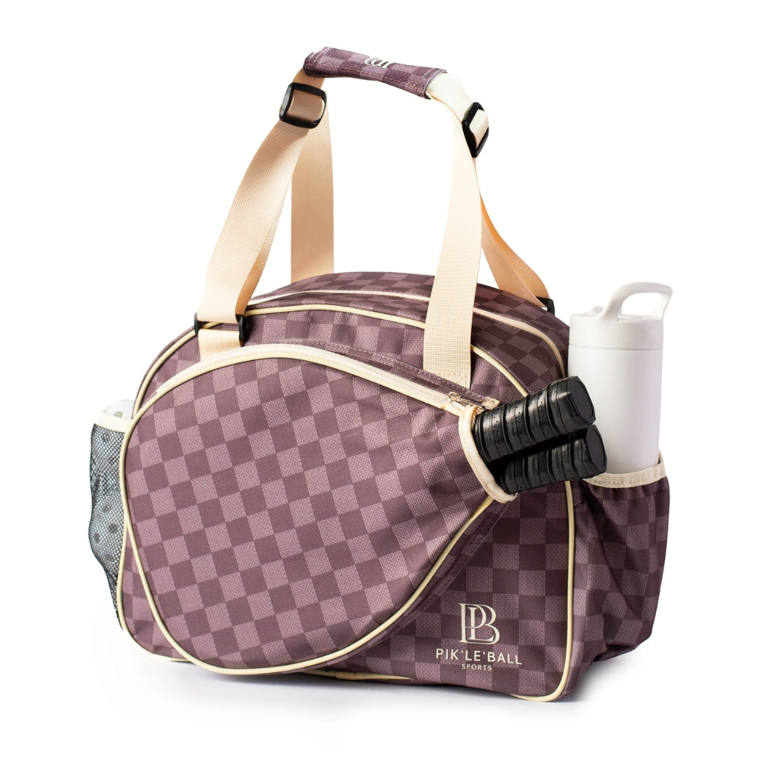 The Checkered Chic Brown Premium Women's Pickleball Bag by Pik'le'Ball Sports features a brown checkered design, beige straps, and mesh and zip pockets for paddles and a water bottle, making it a stylish choice for women players.