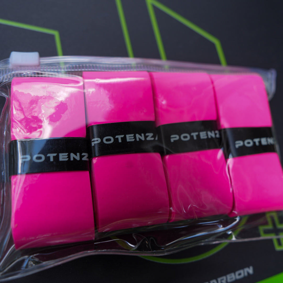 A clear zippered pouch holds four bright pink PROX Tacky Overgrips by Potenza Pickleball, each wrapped with a black strip labeled POTENZA in white, resting on a dark surface with neon green geometric patterns in the background.