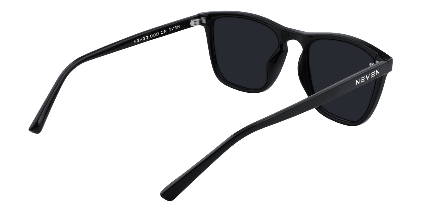 A rear-angled view of Neven Eyewear's Canova sunglasses from the Cambridge collection, featuring black rectangular frames, dark lenses, slightly curved arms, and “NEVEN” in white on the left temple and inside the right arm.