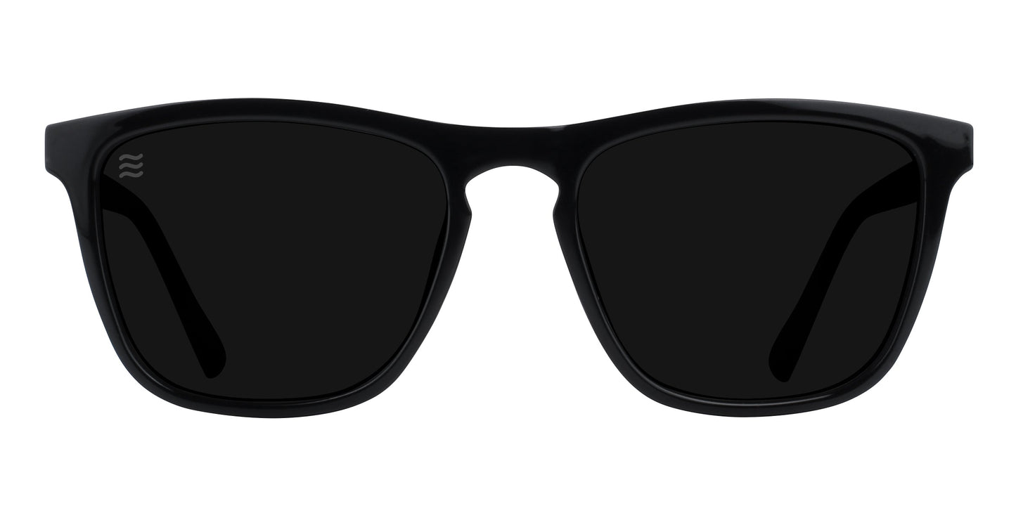 The Neven Eyewear Nix sunglasses feature black, thick rectangular frames with dark polarized UV400 lenses and a subtle logo on the left lens. Shown front-facing on a white background.