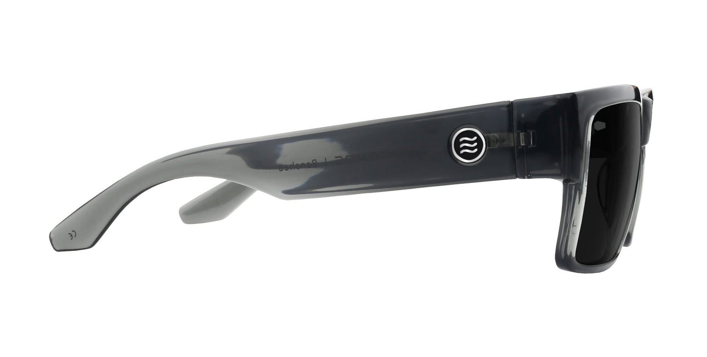 Side view of the Banshee sunglasses by Neven Eyewear, featuring sleek rectangular frames in glossy dark gray, black lenses, and a small circular logo with three wavy lines for a modern look.