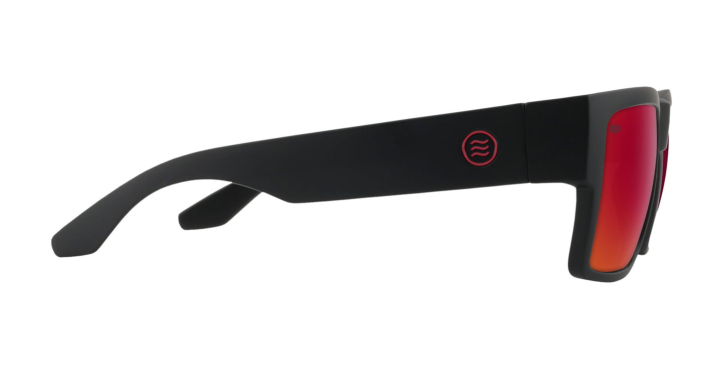 A side view of Neven Eyewear's Havoc sunglasses shows thick black arms, red-orange mirrored lenses, and a circular logo with three wavy red lines—a signature Tim Howley design from the Catacombs collection.