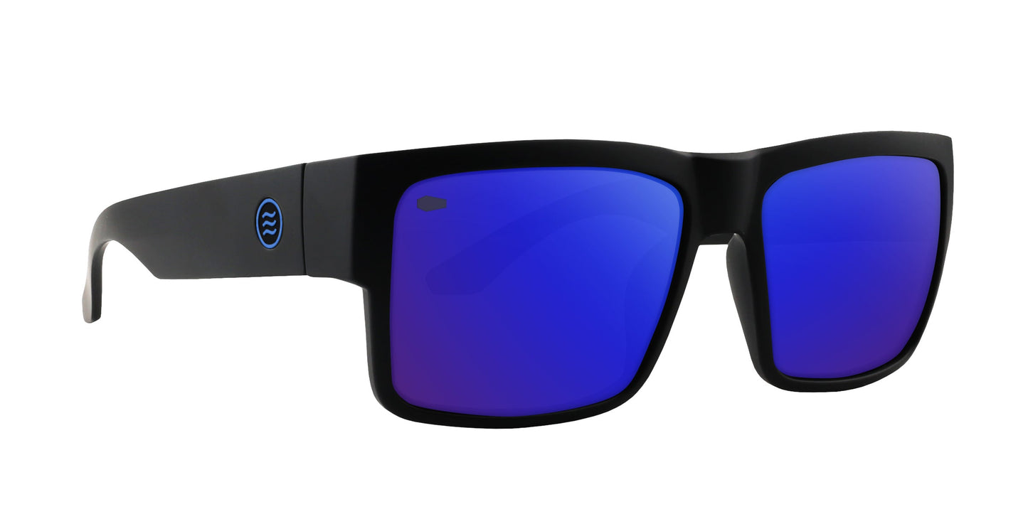 The Scythe by Neven Eyewear features matte black frames with a bold rectangular design, blue mirrored lenses, and a circular blue logo on the arms—giving this gothic-inspired pair a modern, sporty look.