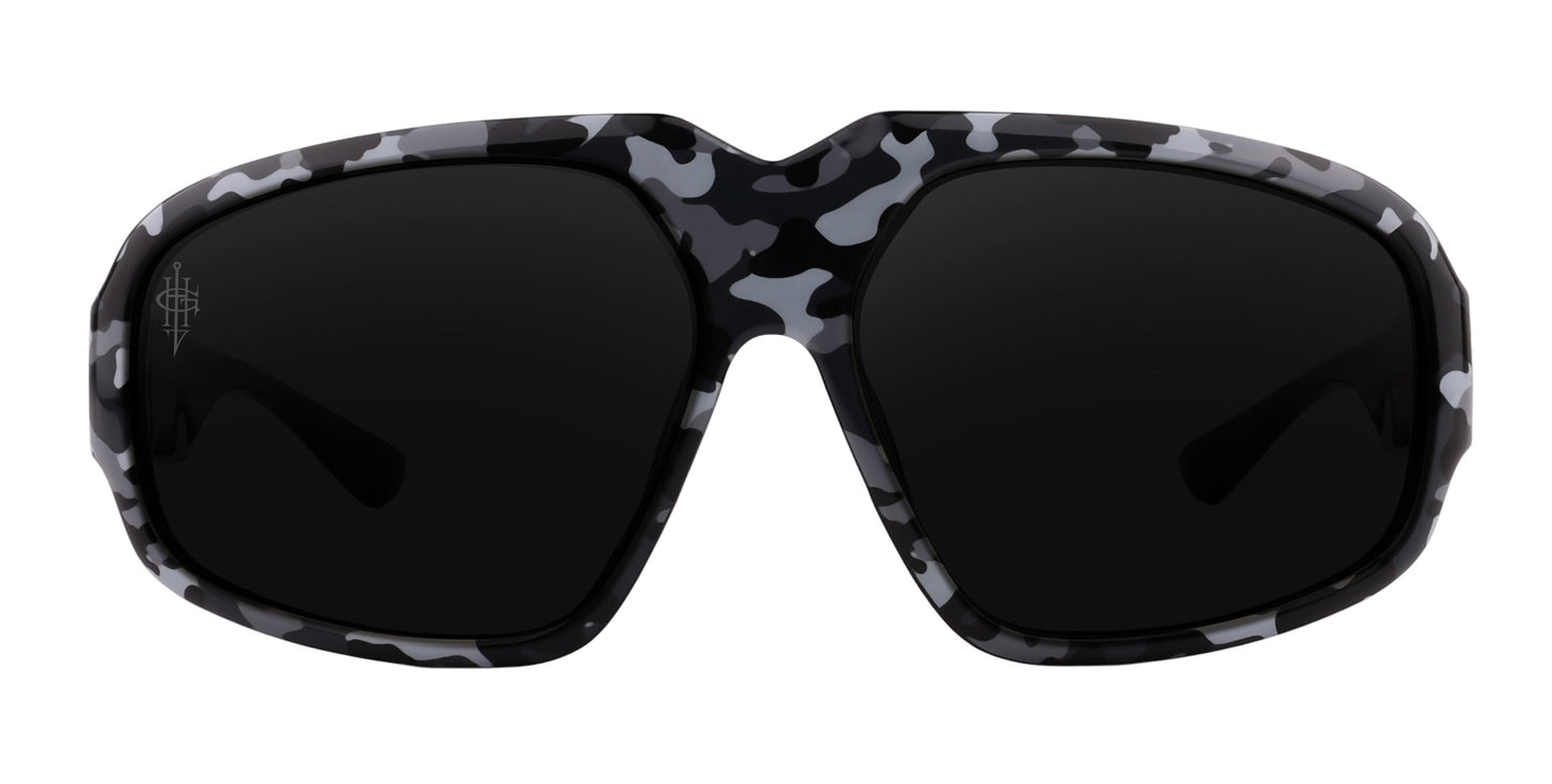 Front view of Neven Eyewear’s A.W.O.L. oversized sunglasses with dark polarized lenses and a black, gray, and white camo-patterned frame. A subtle logo on the upper left lens adds detail to this bold design.