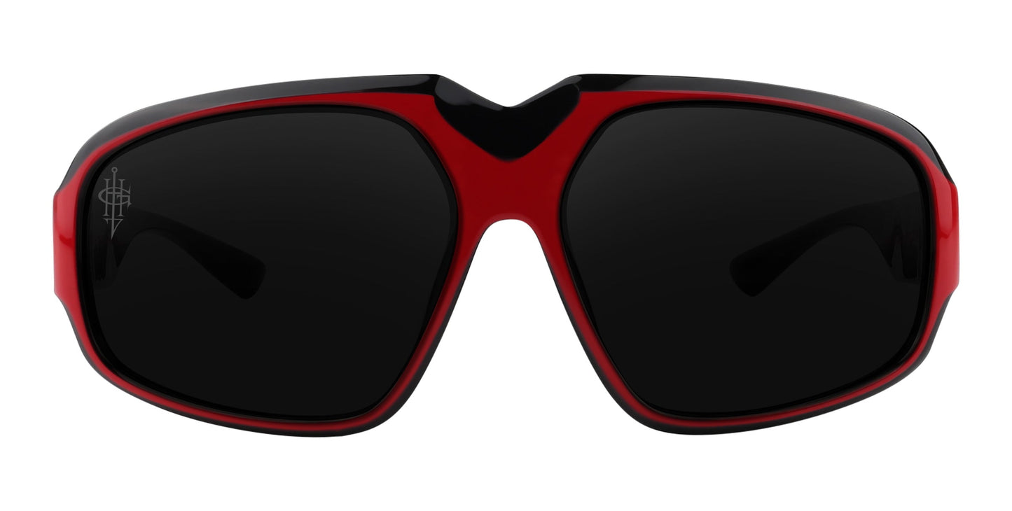 The Neven Eyewear Bloodshot sunglasses feature a thick red and black frame, large polarized black lenses with a subtle logo on the upper left, and a bold V-shaped nose bridge cutout for standout sporty style.