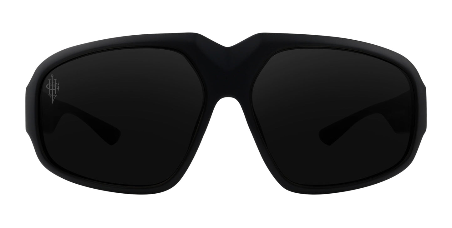 The Neven Eyewear DOA sunglasses feature matte black, oversized frames with thick rims, dark polarized lenses, and a subtle logo on the left lens. The bold modern design has slightly curved wide arms, shown from the front on a white background.