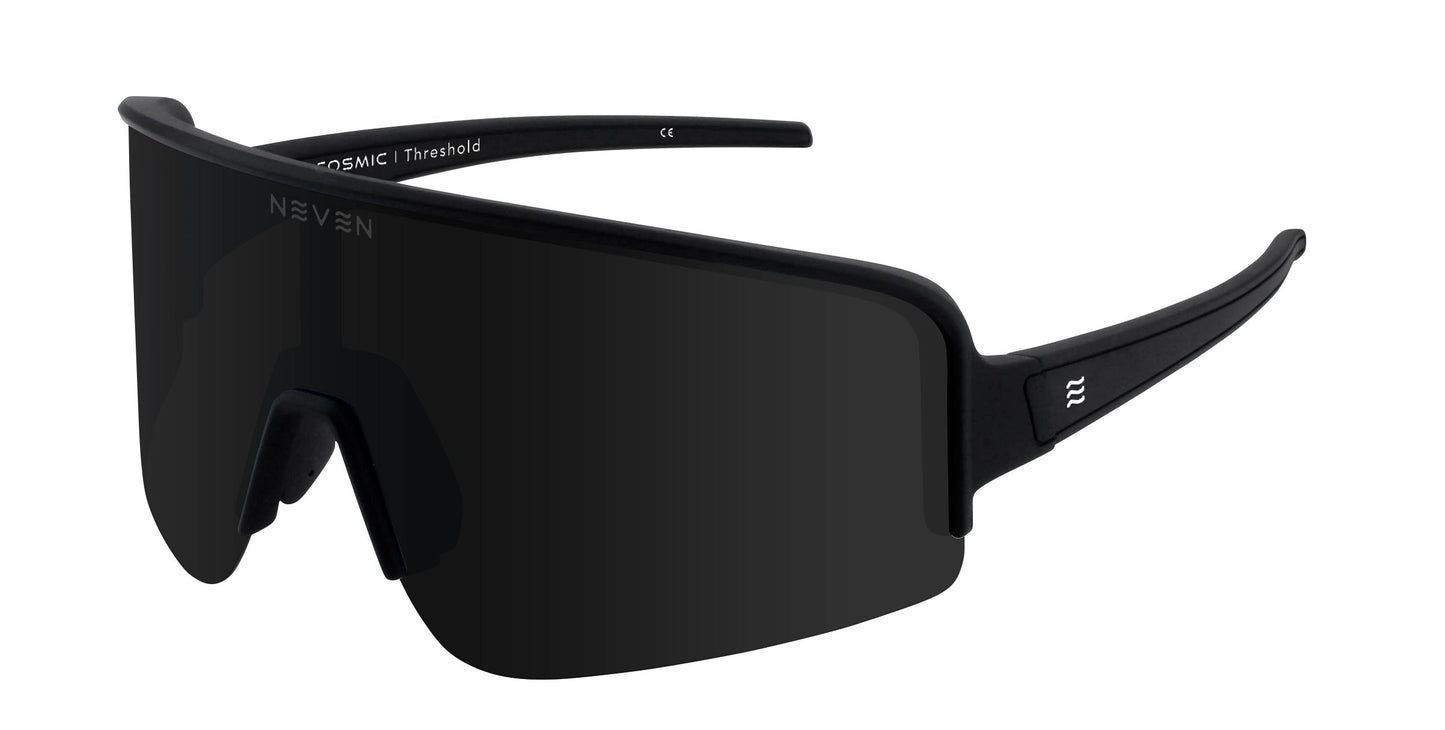 Neven Eyewear’s Threshold sunglasses in sleek all-black feature a single wide, curved lens with polarized UV400 protection, thick arms with a small white logo on the left, and integrated nose pads for a sporty look. Displayed on a plain white background.