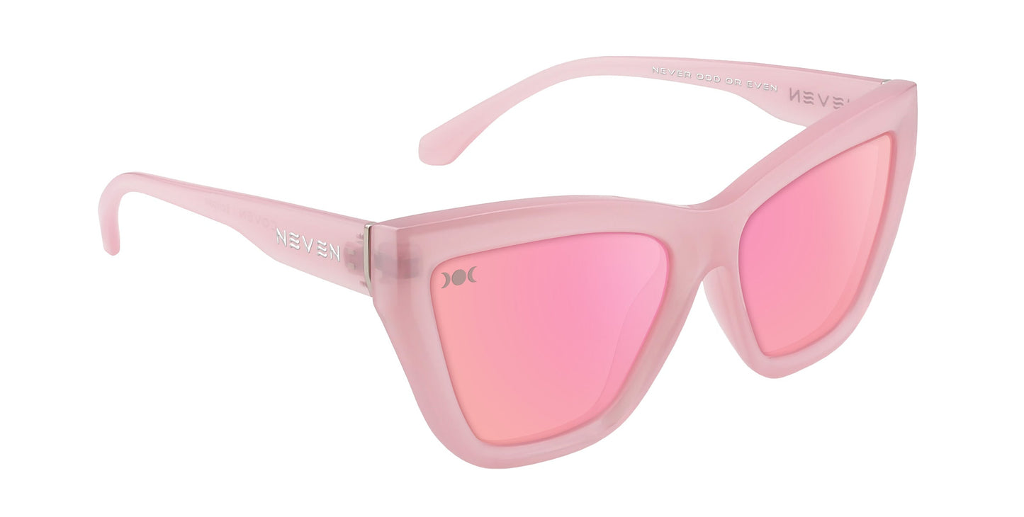 The Eclipse by Neven Eyewear are cat-eye sunglasses with thick, translucent pink frames and matching pink mirrored lenses. Subtle branding near the hinge adds a modern, stylish touch to these standout pink sunglasses.