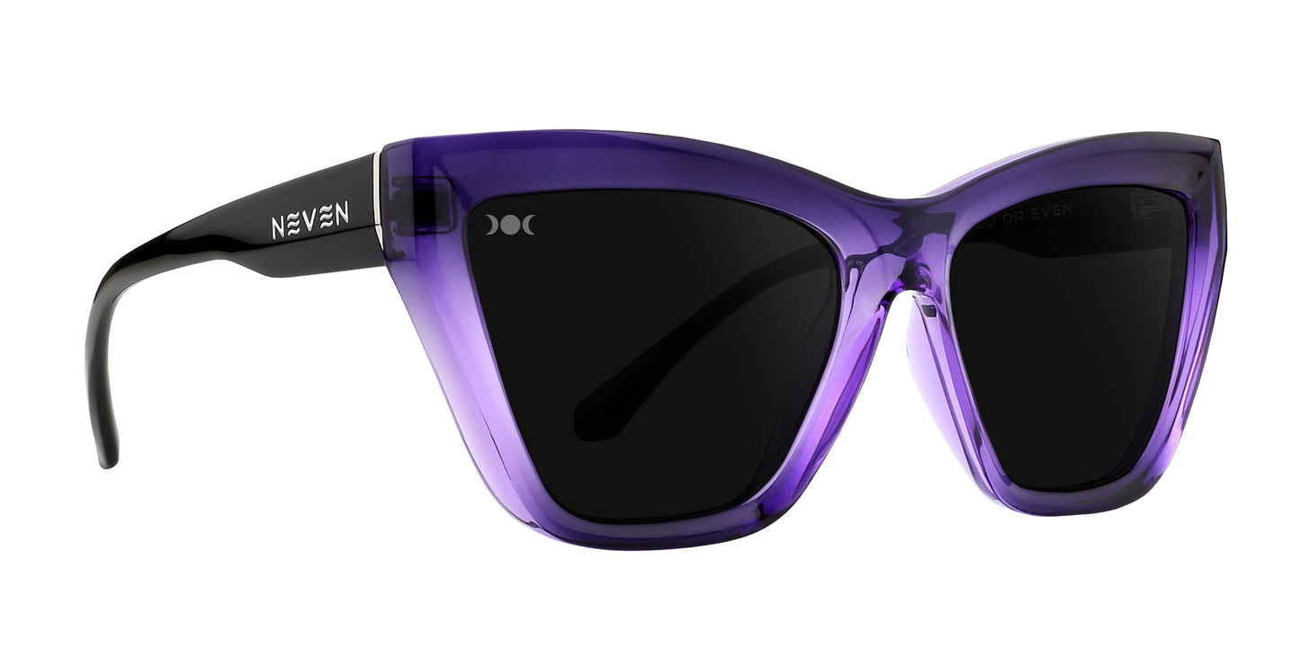 The Ethereal by Neven Eyewear are cat-eye sunglasses with translucent purple frames, black arms, and polarized UV400 dark lenses. NEVEN is printed in white on the left arm. The sunglasses are shown against a white background.