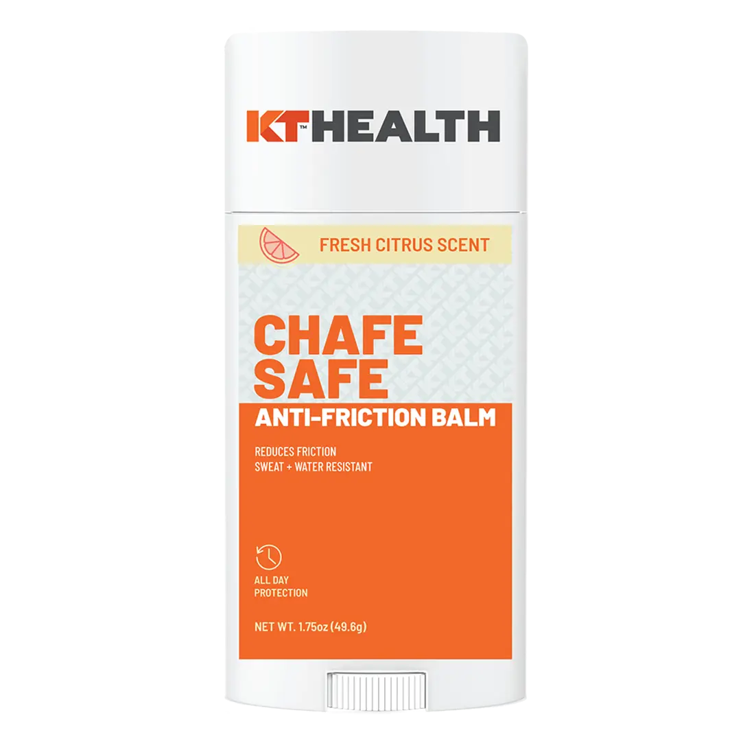 A white stick container labeled "KT Tape" holds "KT Health Chafe Safe™ Anti-Friction Balm" with a fresh citrus scent. The orange and white label highlights chafing protection, sweat and water resistance. Net weight: 1.7 oz (48.5g).