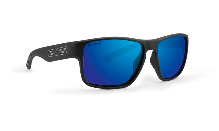 Epoch Eyewear's Charlie Polarized Sunglasses feature black frames and blue mirrored lenses, plus a silver geometric logo on the arms. Shown angled to highlight both front and left, these adventure sunglasses reflect light for standout style.
