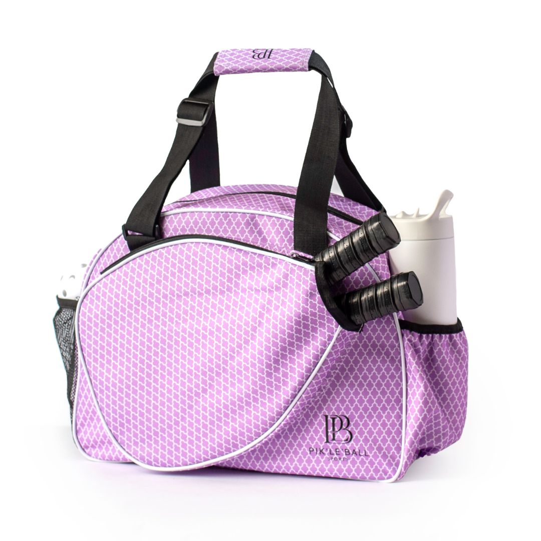 The Classy Orchid Premium Women's Pickleball Bag by Pik'le'Ball Sports features a chic lavender design with white geometric pattern, black straps, and mesh bottle pocket—blending function and style perfectly on or off the court.