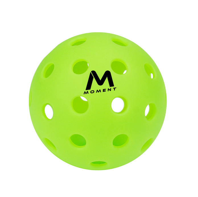 A vibrant yellow-green Moment SF1 -Comp Performance Pickleball from Moment Pickleball features multiple evenly spaced holes and "MOMENT" with a large M logo in black on its surface, shown against a plain white background.