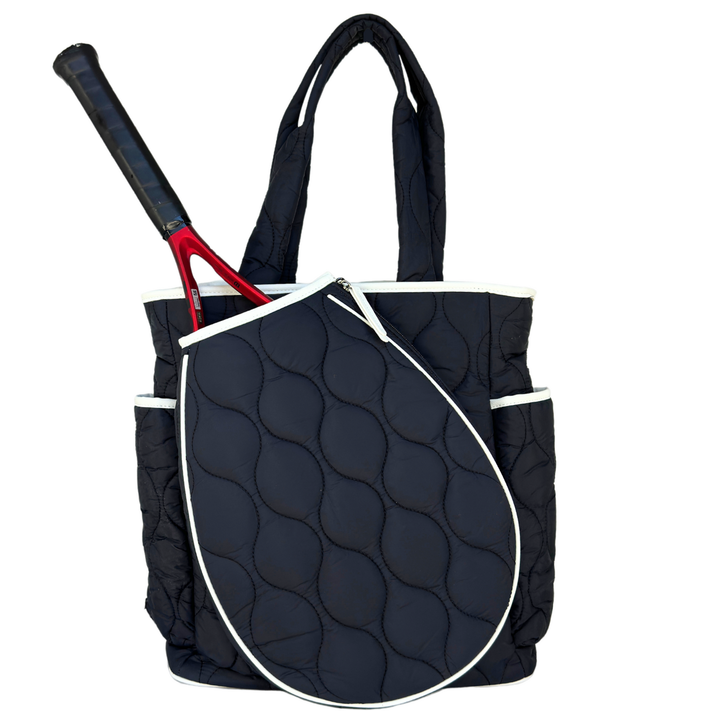 The Queen of the Court Park Ave Tennis Convertible Bag/Backpack for women features a navy blue quilted design with white trim, side pockets, an external zippered racket compartment, and sturdy handles. Shown with a black and red handle racket.
