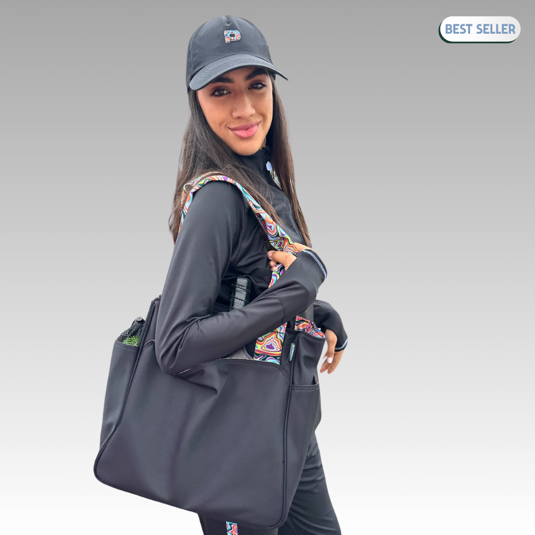 A woman in black athletic wear and cap smiles while holding the Lulu Pickleball Tote by Playly Store, featuring colorful patterned straps. The background is a gray gradient with a "Best Seller" label in the top right corner.