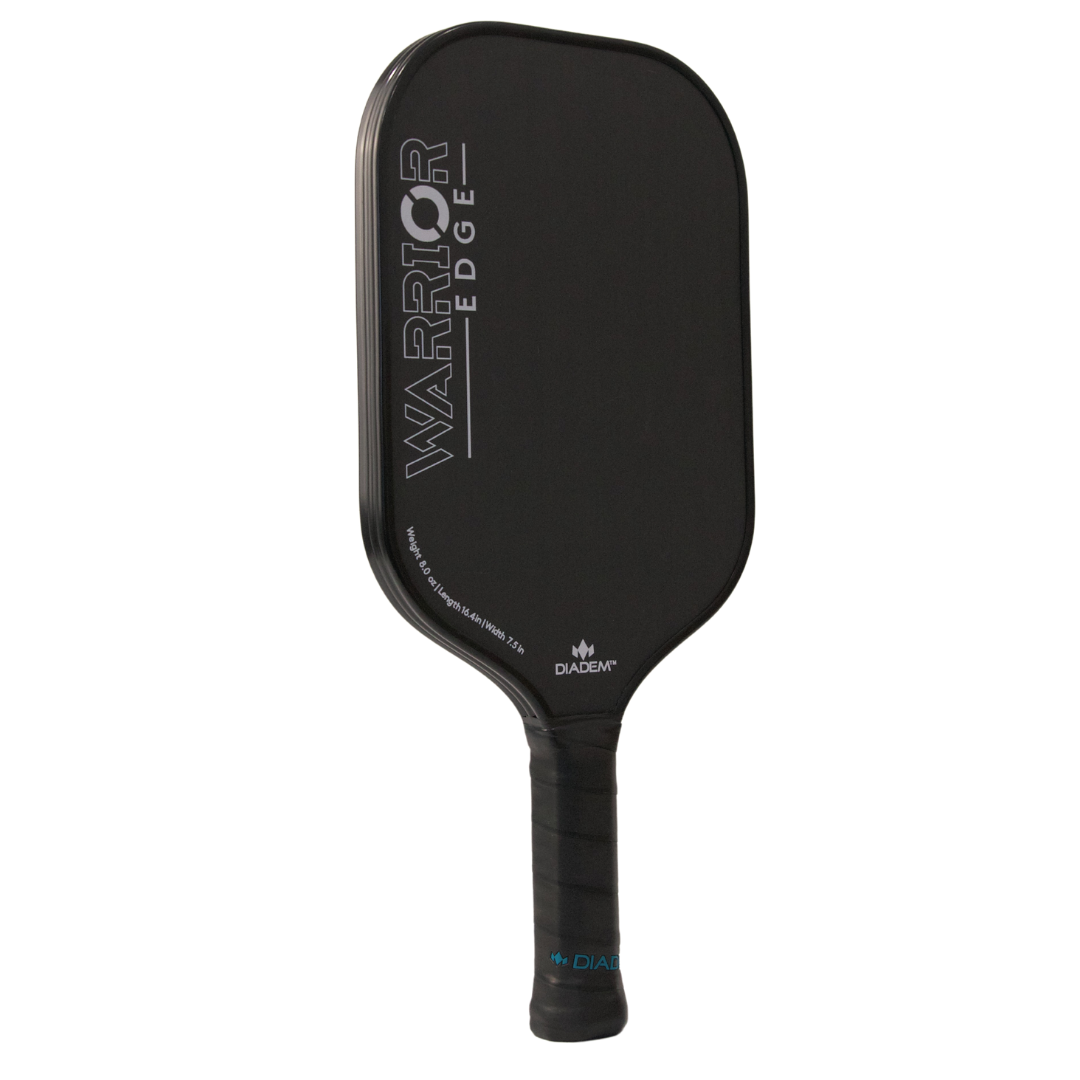 The Diadem Sports Warrior Edge pickleball paddle features a sleek black design, etched carbon face, “WARRIOR EDGE” in silver, USAPA approval, a black grip-tape handle, and the “DIADEM” logo near the base.