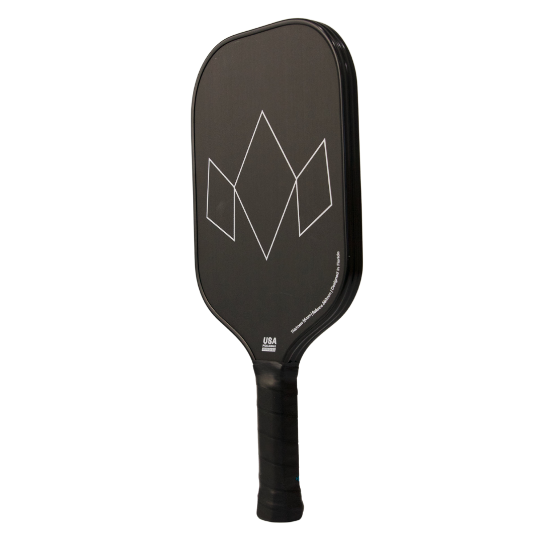 The Diadem Sports Warrior Edge is a black USAPA-approved pickleball paddle with a minimalist matte finish, white geometric diamond design, rounded edges, and a black grip handle.