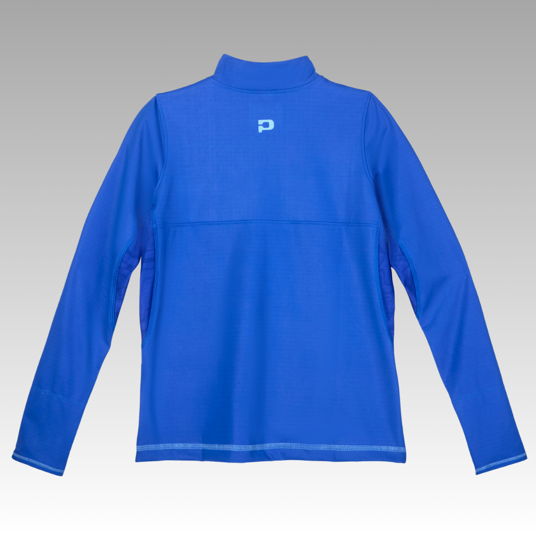 The Soleil Tech Shirt by Playly Store is a royal blue long-sleeve athletic top shown from the back on a gray gradient background. It features breathable fabric, UV protection, a high collar, subtle stitching, and a light blue "P" logo.
