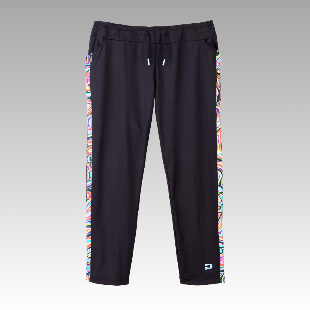 The Playly Store Lexi Warm-Up Pant is a black straight-fit athletic pant in comfy SwiftForm fabric, featuring colorful abstract side stripes, ankle zippers, an elastic drawstring waist, and a small light blue logo on the leg.