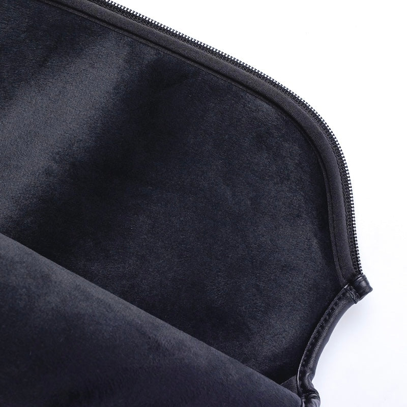 A close-up of a black zippered case reveals its soft, velvety lining and curved zipper edge, ideal for protecting the body helix X5 Kevlar Pickleball Paddle—USAP Approved—especially its cushioned grip. Lighting enhances the plush texture.