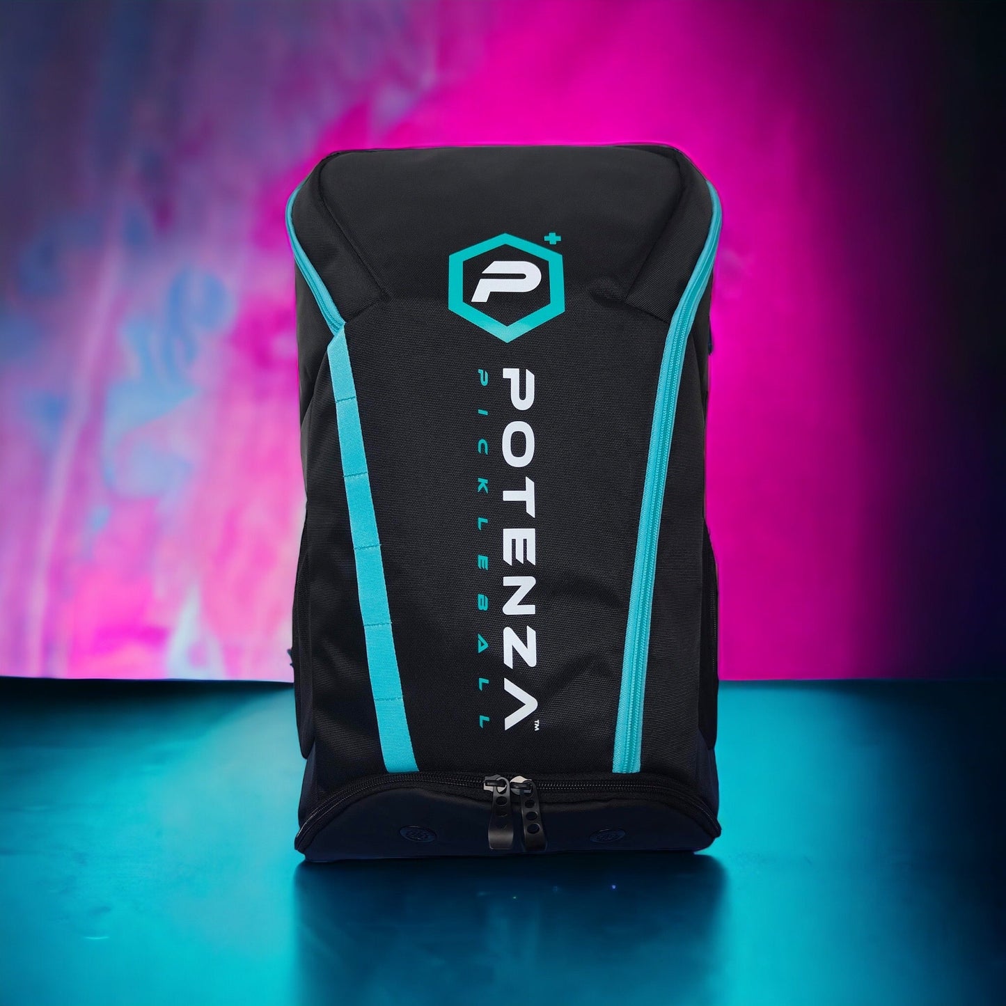 A black Potenza Pickleball Pro Player Logo Bag (holds 4-5 paddles) with teal accents and white vertical branding stands upright on a blue surface, highlighted by abstract pink and purple lighting in the background.