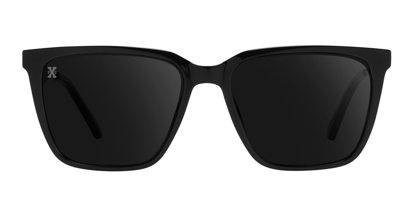 A front view of Neven Eyewear’s Mamba sunglasses, featuring glossy black rectangular frames, dark polarized lenses, and a silver X logo on the left lens. Set against a plain white background to highlight the design.