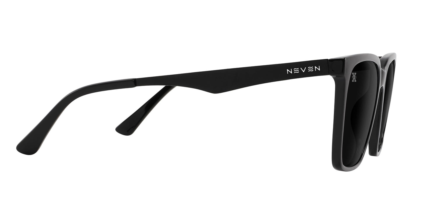 A side view of the Neven Eyewear Mamba sunglasses shows black, thick frames with NEVEN in white on the temple arm. Dark-tinted polarized lenses and a modern design complete this stylish pair.