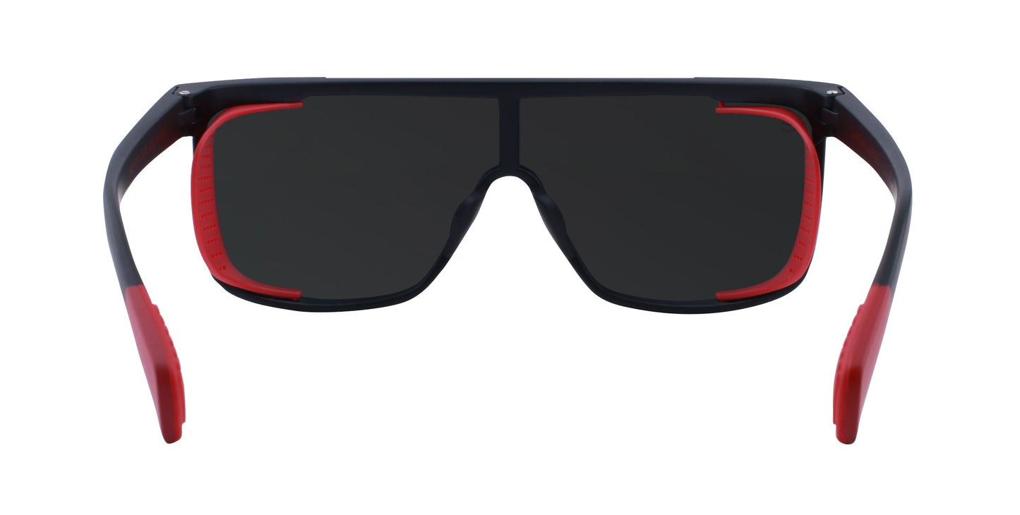 The Neven Eyewear Blood Moon sunglasses feature large black impact-resistant lenses, a modern wide frame with bold red accents on the inner temples and nose area, and outward-curving temple ends for sleek sporty style.