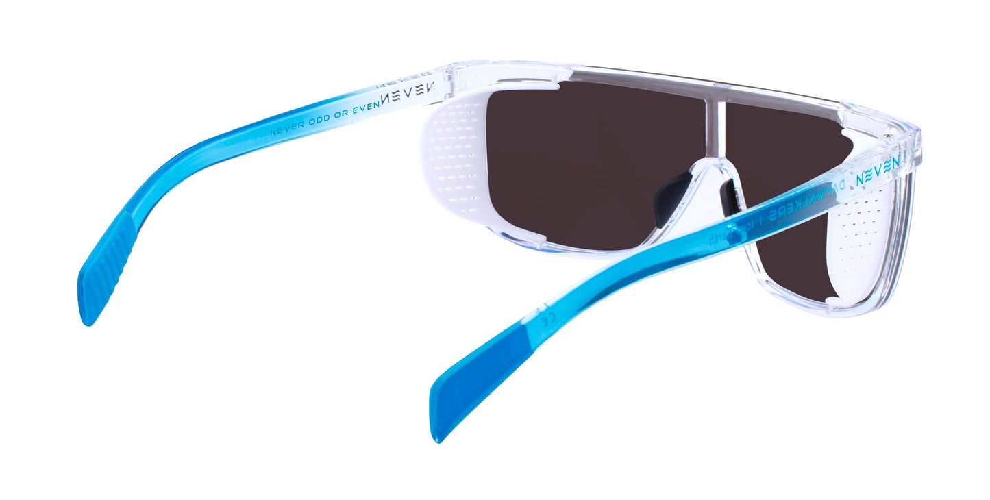 Neven Eyewear’s Iced Earth sunglasses feature clear frames, black-tinted lenses, and blue vented arms with “NEVER OD OR EVEN EY” in white. Enjoy style and reliable UV400 protection from harmful rays.