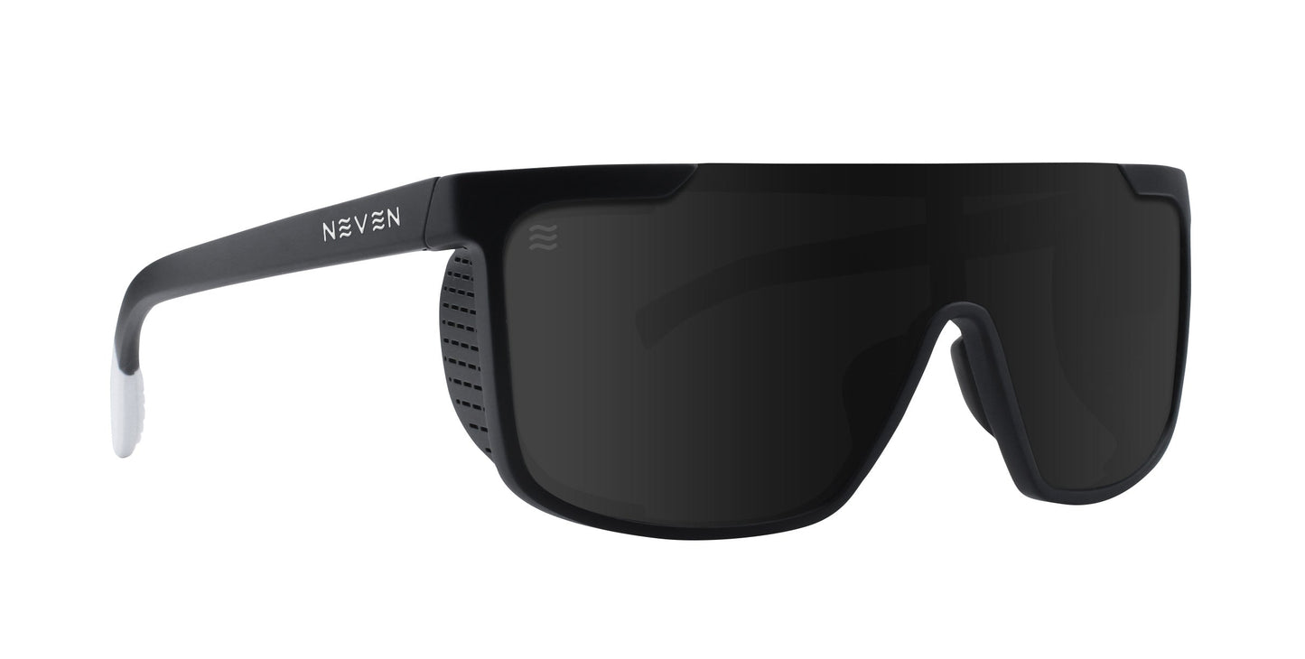 Pitch Black by Neven Eyewear: wraparound black sunglasses with wide, single-piece dark tinted UV400 lenses, thick frames featuring side vents and a white NEVEN logo. Curved arms have white tips for grip. Impact-resistant protection.