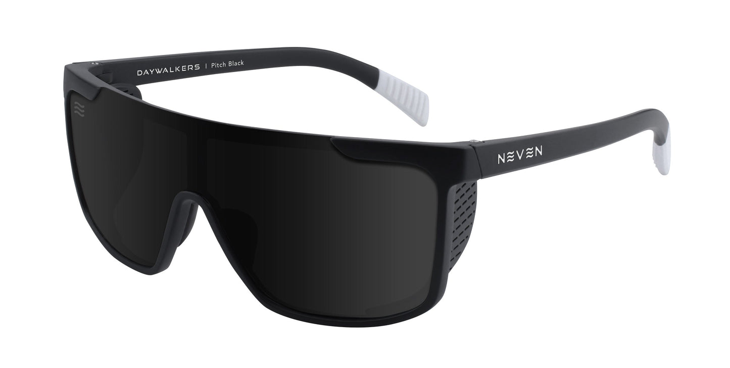 Neven Eyewear's Pitch Black sunglasses feature impact-resistant wraparound black frames with white-accented temple tips, vent details near the hinges, rectangular dark lenses, and “DAYWALKERS | Pitch Black” and “NEVEN” branding.