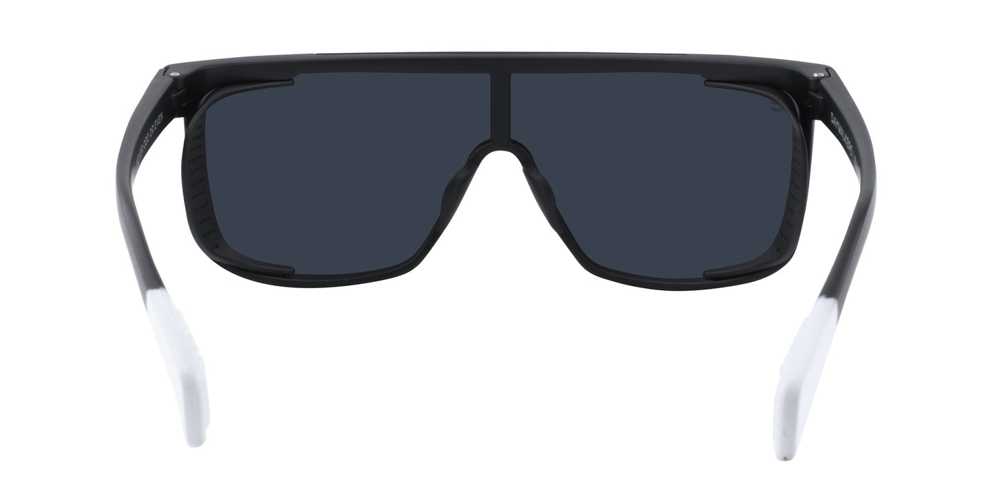 Neven Eyewear’s Pitch Black sunglasses feature large, rectangular black lenses and a thick black frame. The wide arms fade from black to white at the ends, and UV400 protection is provided. Shown from the front against a white background.