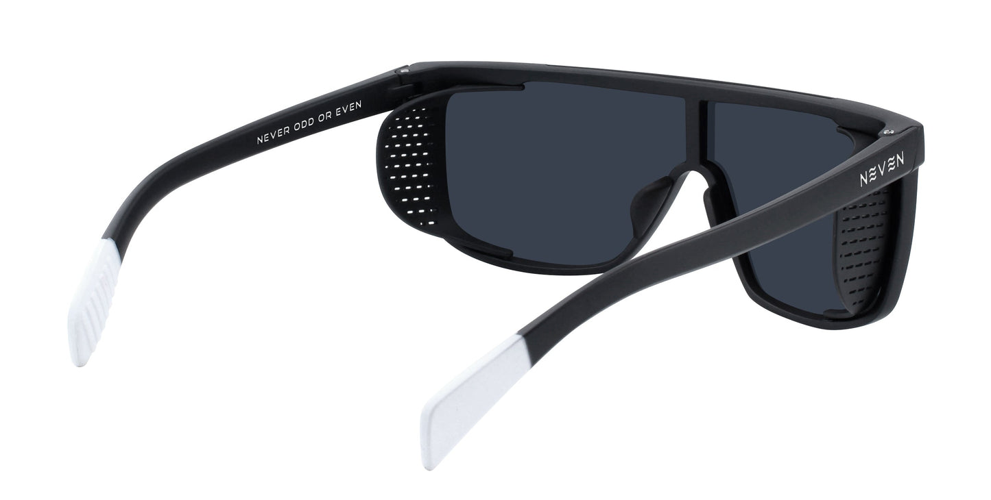 Pitch Black by Neven Eyewear: Rectangular black sunglasses with dark lenses, white-tipped arms, removable perforated side shields, “NEVER ODD OR EVEN” on the inside arm and “NEVEN” outside. UV400 stylish protection.